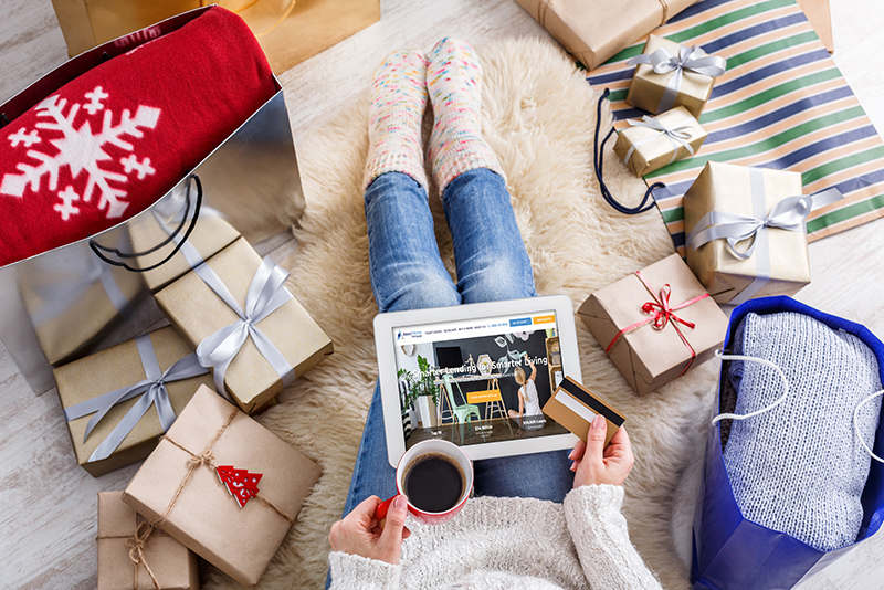 Woman online holiday shopping from livingroom