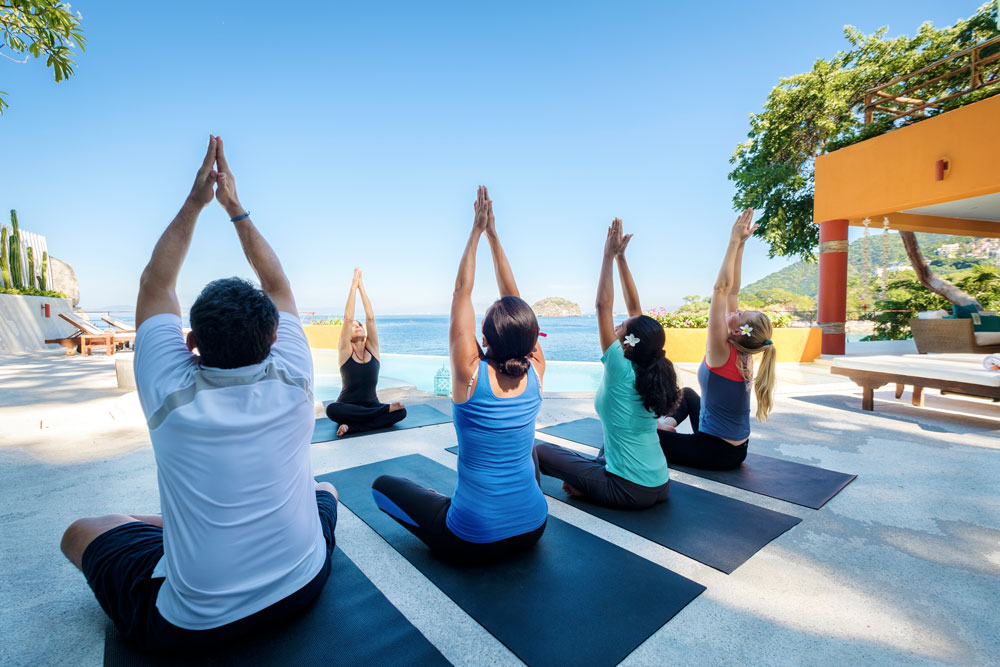 People Doing Yoga By The Beach