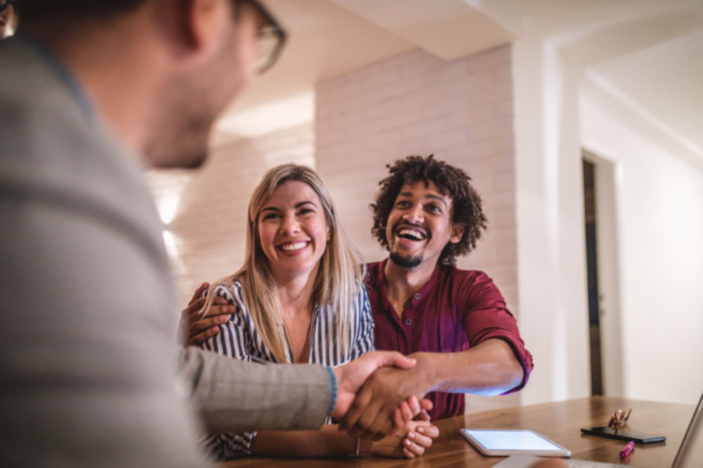Happy Couple Getting A Loan From A loan Officer