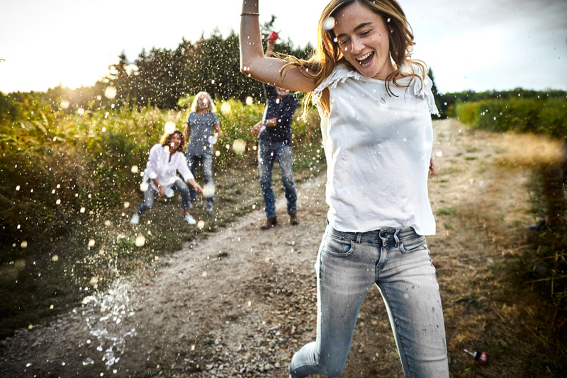 Young girl playing in water with friends