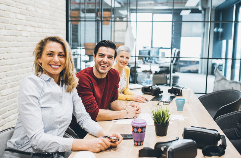 Young and happy business people in modern office.