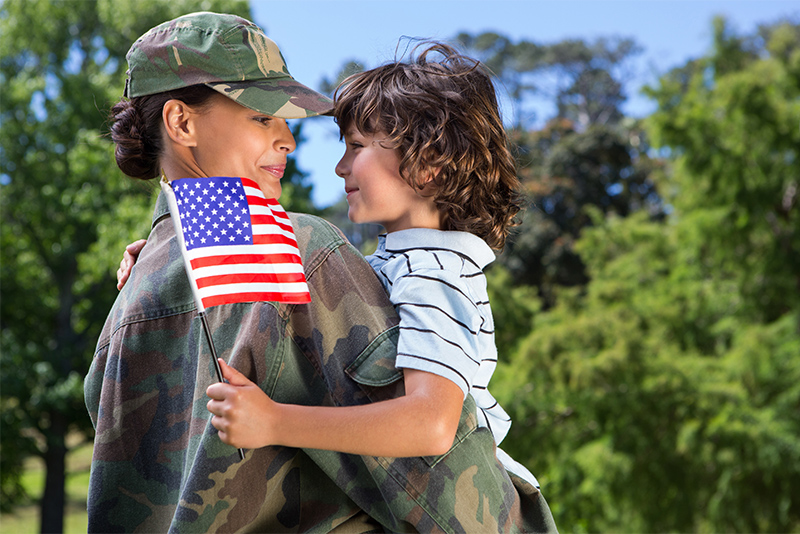 Female Veteran reunited with her son on a sunny day