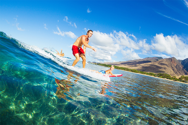 Father and Son Surfing Together Riding Blue Ocean Wave
