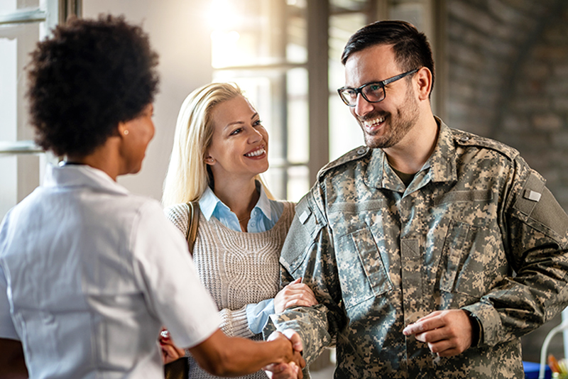 Happy Military Man Shaking Hands With Doctor At Medical Counselling