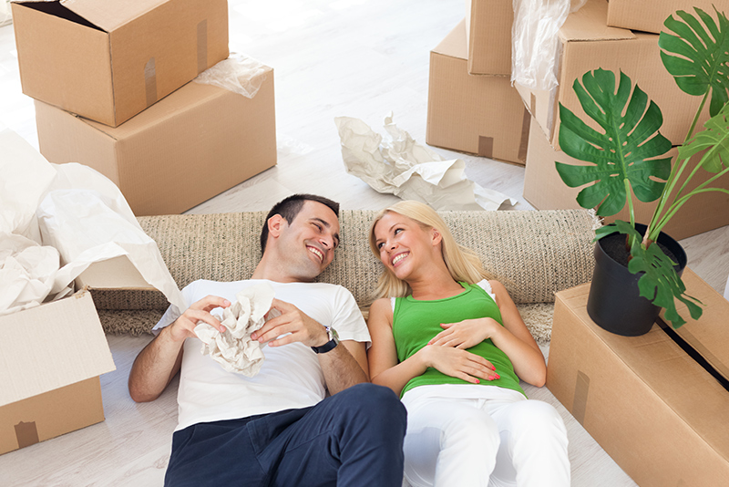 Young Smiling Couple Relaxing At Home