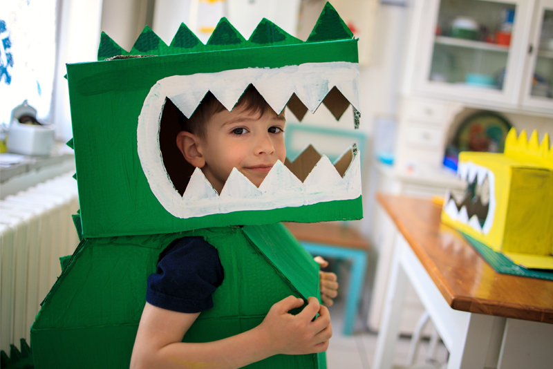 Child in dinosaur Halloween costume