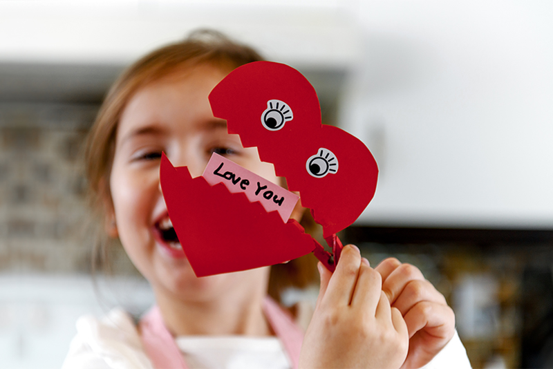 Young girl with Valentines heart saying I Love You