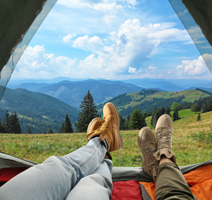Couple looking out camping tent
