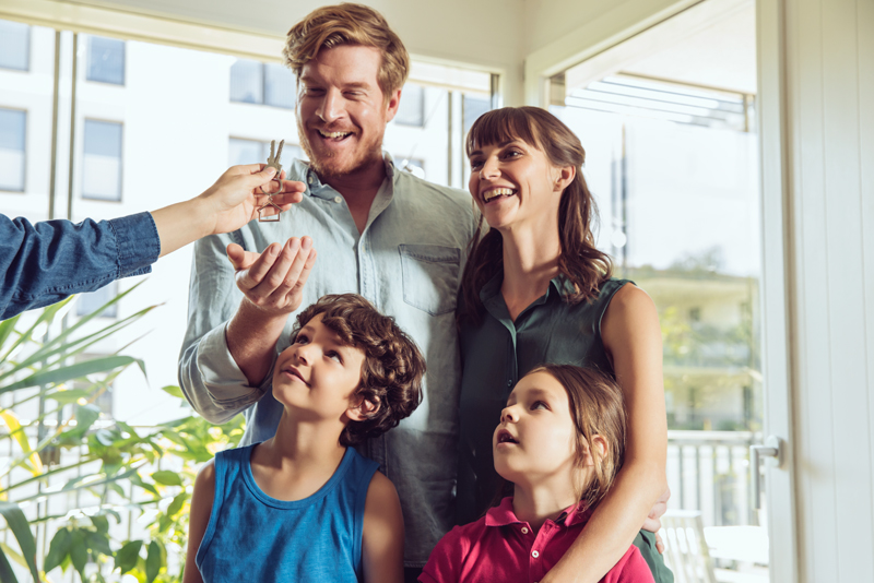 Happy family gettng keys to new home