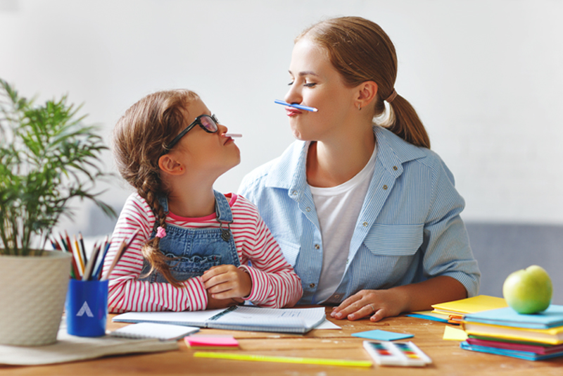 Mother with daugher having fun with arts and crafts