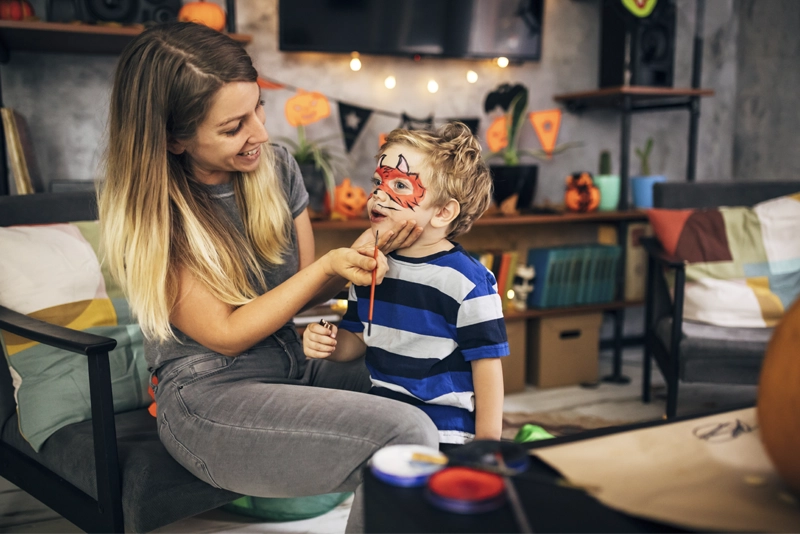 Mother face painting son for Halloween