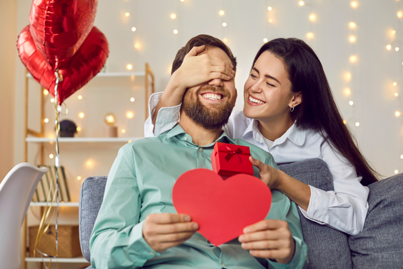 Happy couple celebrating Valentine's Day with gifts