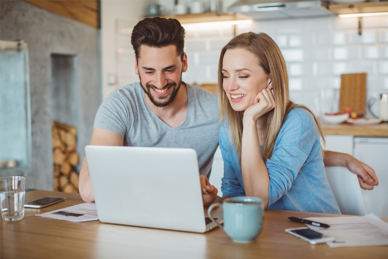 Happy couple working on computer