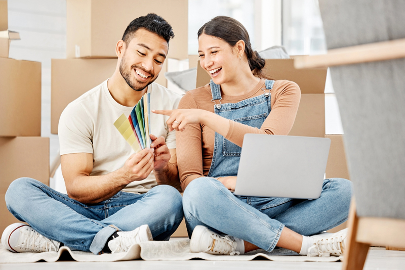 Happy couples looking at paint swatches for new home