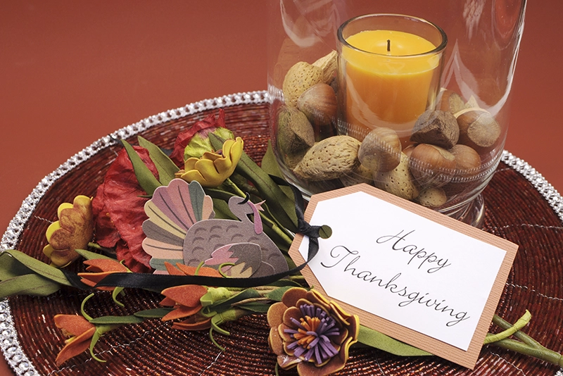 Thanksgiving place setting with candle and various nuts